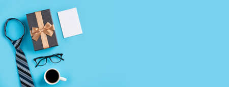 Father's Day gift. Top view design concept of holiday idea with greeting card on blue table background.の写真素材