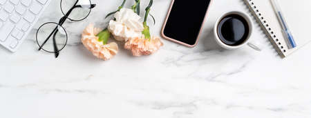Mother's Day concept. Top view of greeting with carnation flower on mother's office table desk background.の写真素材