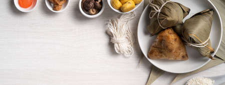Zongzi. Delicious traditional rice dumpling food for Dragon Boat Duanwu Festival over wooden table background top view.の写真素材