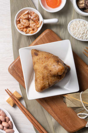 Zongzi. Delicious traditional rice dumpling food for Dragon Boat Duanwu Festival over wooden table...