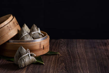 Zongzi. Rice dumpling for Chinese traditional Dragon Boat Festival (Duanwu Festival) on dark wooden table background.の写真素材