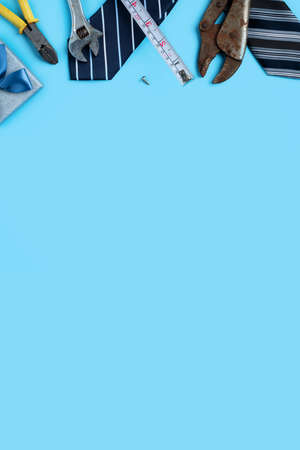 Top view design concept of Father's day and labor day with working tools on blue background.