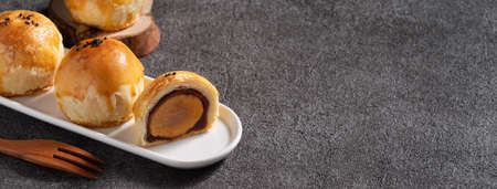 Close up of Moon cake yolk pastry, mooncake for Mid-Autumn Festival holiday on gray table background