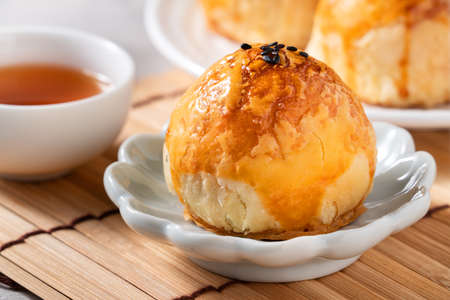Close up of Moon cake yolk pastry, mooncake for Mid-Autumn Festival holiday on gray table backgroundの写真素材