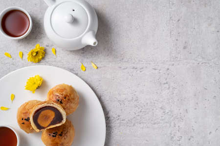 Top view design concept of Moon cake yolk pastry, mooncake for Mid-Autumn Festival holiday on dark gray table backgroundの写真素材