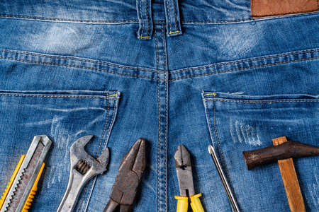 Top view design concept of Labor Day with working tools on blue jeans background.の写真素材