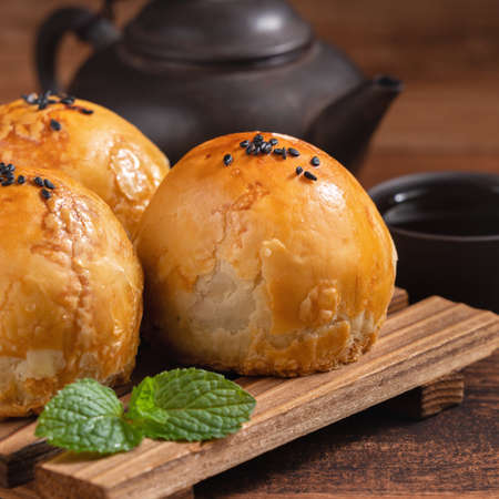 Close up of Moon cake yolk pastry, mooncake for Mid-Autumn Festival holiday on wooden table backgroundの写真素材