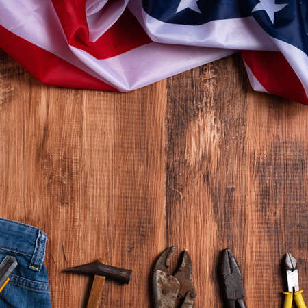 Top view design concept of Labor Day with working tools and jeans on wooden table background.の写真素材