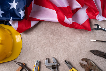 Top view design concept of American Labor Day with working tools on gray table background.の写真素材