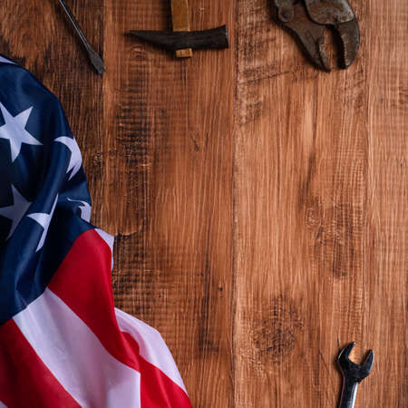 Top view design concept of Labor Day with working tools and jeans on wooden table background.の写真素材