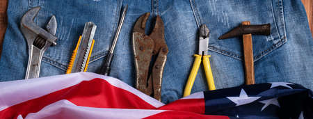 Top view design concept of Labor Day with working tools and jeans on wooden table background.の写真素材