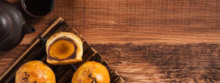 Top view of Moon cake yolk pastry, mooncake for Mid-Autumn Festival holiday on wooden table...