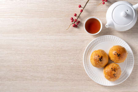 Top view design concept of Moon cake yolk pastry, mooncake for Mid-Autumn Festival holiday on wooden...