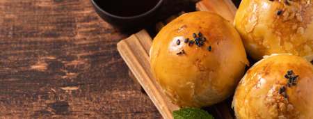 Close up of Moon cake yolk pastry, mooncake for Mid-Autumn Festival holiday on wooden table backgroundの写真素材