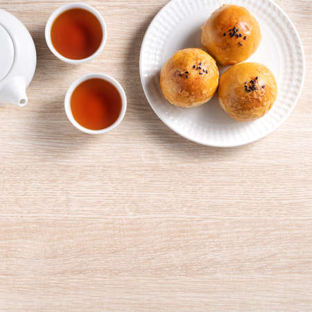 Top view design concept of Moon cake yolk pastry, mooncake for Mid-Autumn Festival holiday on wooden table backgroundの写真素材