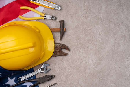 Top view design concept of American Labor Day with working tools on gray table background.の写真素材