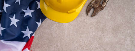 Top view design concept of American Labor Day with working tools on gray table background.の写真素材