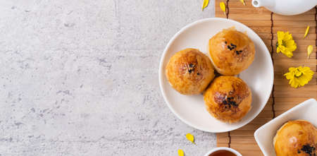 Top view design concept of Moon cake yolk pastry, mooncake for Mid-Autumn Festival holiday on dark gray table backgroundの写真素材