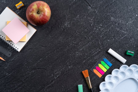Back to school student design concept, top view of stationery over slate black table background with copy space.の写真素材