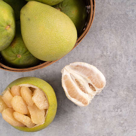 Top view of fresh pomelo on gray cement table background for Mid-Autumn Festival fruit.