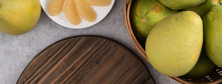 Top view of fresh pomelo on gray cement table background for Mid-Autumn Festival fruit.の写真素材