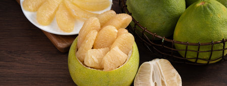 Close up of fresh peeled pomelo on wooden table background for Mid-Autumn Festival fruit.の写真素材