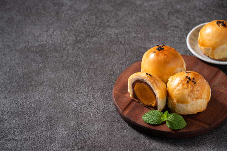 Close up of moon cake yolk pastry, mooncake for Mid-Autumn Festival holiday on dark gray table backgroundの写真素材
