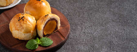 Close up of moon cake yolk pastry, mooncake for Mid-Autumn Festival holiday on dark gray table backgroundの写真素材
