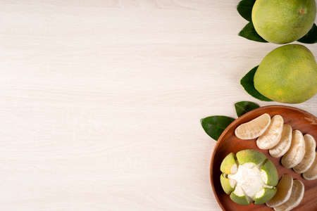 Top view of fresh pomelo on bright wooden table background for Mid-Autumn Festival fruit.の写真素材