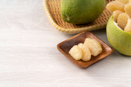 Close up of fresh peeled pomelo on wooden table background for Mid-Autumn Festival fruit.の写真素材