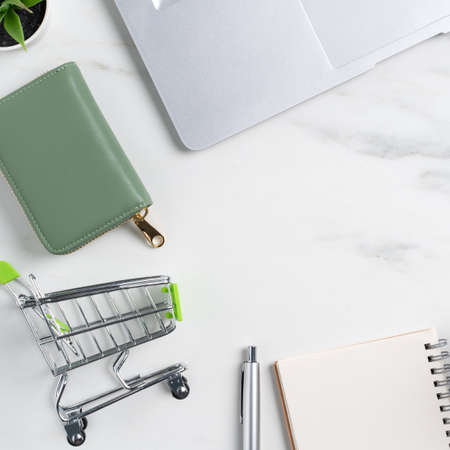 Top view of online shopping concept with credit card and laptop computer isolated on office marble white table background.の写真素材