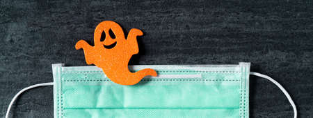 Top view of Halloween concept decoration non-woven fabric on dark black slate background with mask.の写真素材