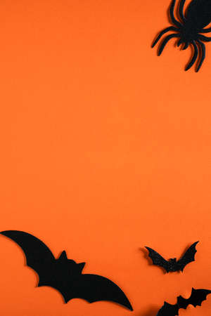 Top view of creative Halloween concept decoration on orange paper table background.