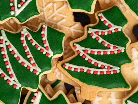 Top view of decorated green plain flavor gingerbread Christmas tree cookie with copy space, concept...