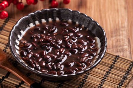 Close up of adzuki red bean soup in a bowl on wooden table background for eating.の写真素材