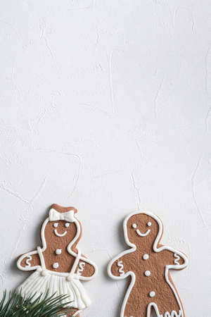Top view of decorated Christmas gingerbread cookies with decorations on white table background with copy space, concept of holiday celebration.の写真素材