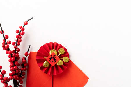 Top view of Chinese lunar new year background copy space design concept with red berry holly and festive decoration, the word inside picture means blessing.の写真素材