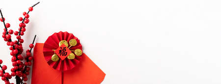 Top view of Chinese lunar new year background copy space design concept with red berry holly and festive decoration, the word inside picture means blessing.の写真素材