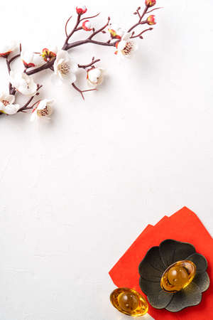 Top view of Chinese lunar new year background copy space design concept with white plum flower and festive decoration, the word inside picture means blessing.の写真素材