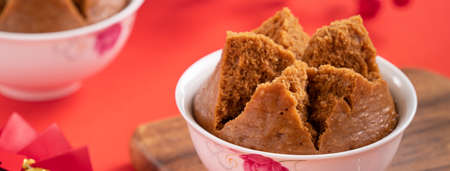 Close up of delicious Chinese steamed sponge cake named Fa Gao for lunar new year festival traditional food over red table background.の写真素材