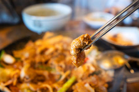 Close up of ssam Korean BBQ, pan-fried black pork with lettuce meal in Korea restaurant, fresh delicious korean cuisine.の写真素材