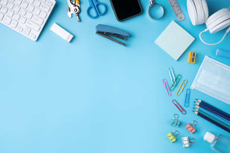 Online learning and back to school design concept. Top view of student table with headphone and...