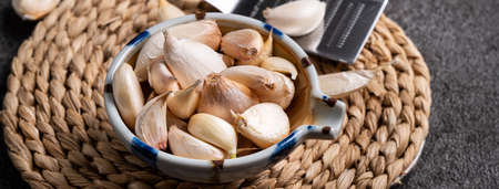 Close up of fresh garlic cloves on black table background.