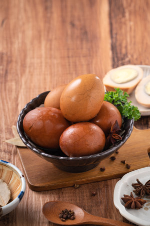 Close up of delicious traditional Taiwanese famous food tea eggs with in a bowl on wooden table background.の写真素材