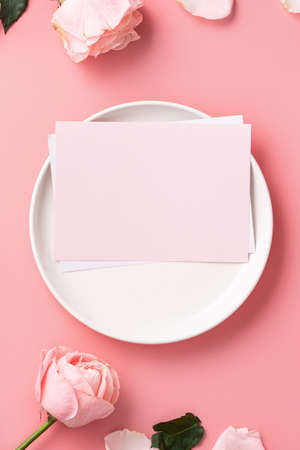 Top view of Mother's Day sending gift and meal design concept background with pink rose flower on pink table backgroundの写真素材