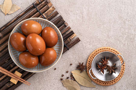 Top view of delicious traditional Taiwanese famous food tea eggs with in a bowl on gray table...