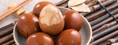 Close up of delicious traditional Taiwanese famous food tea eggs with in a bowl on gray table background.の写真素材