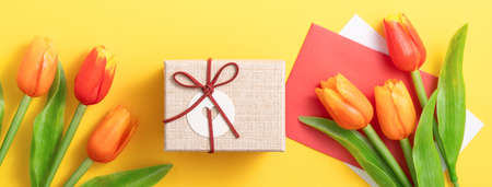 Mother's day background concept. Top view design of holiday greeting gift with tulip bouquet on...