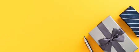 Father's day gift background design concept with gift box idea and necktie on yellow background.の写真素材