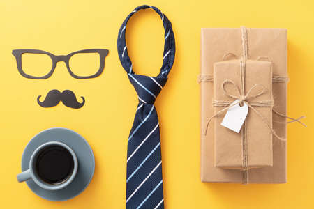 Father's day gift background design concept with gift box idea and necktie on yellow background.